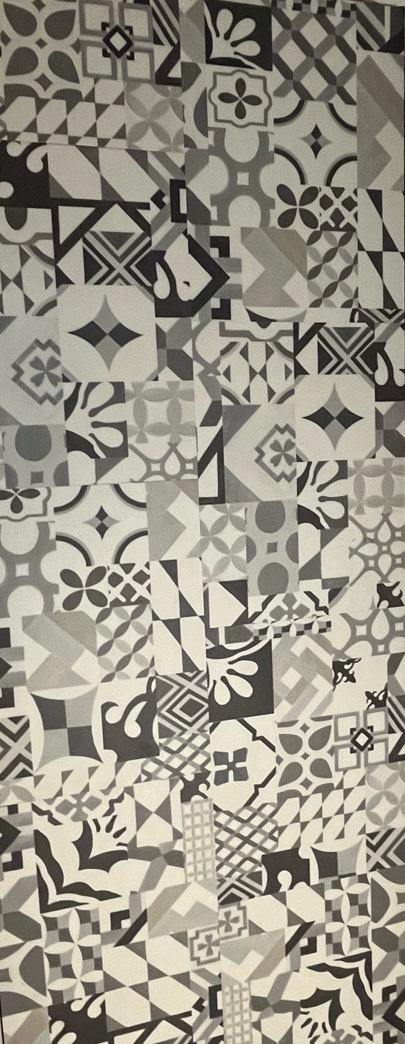 Decorative luxury vinyl tile flooring with intricate pattern in kitchen area