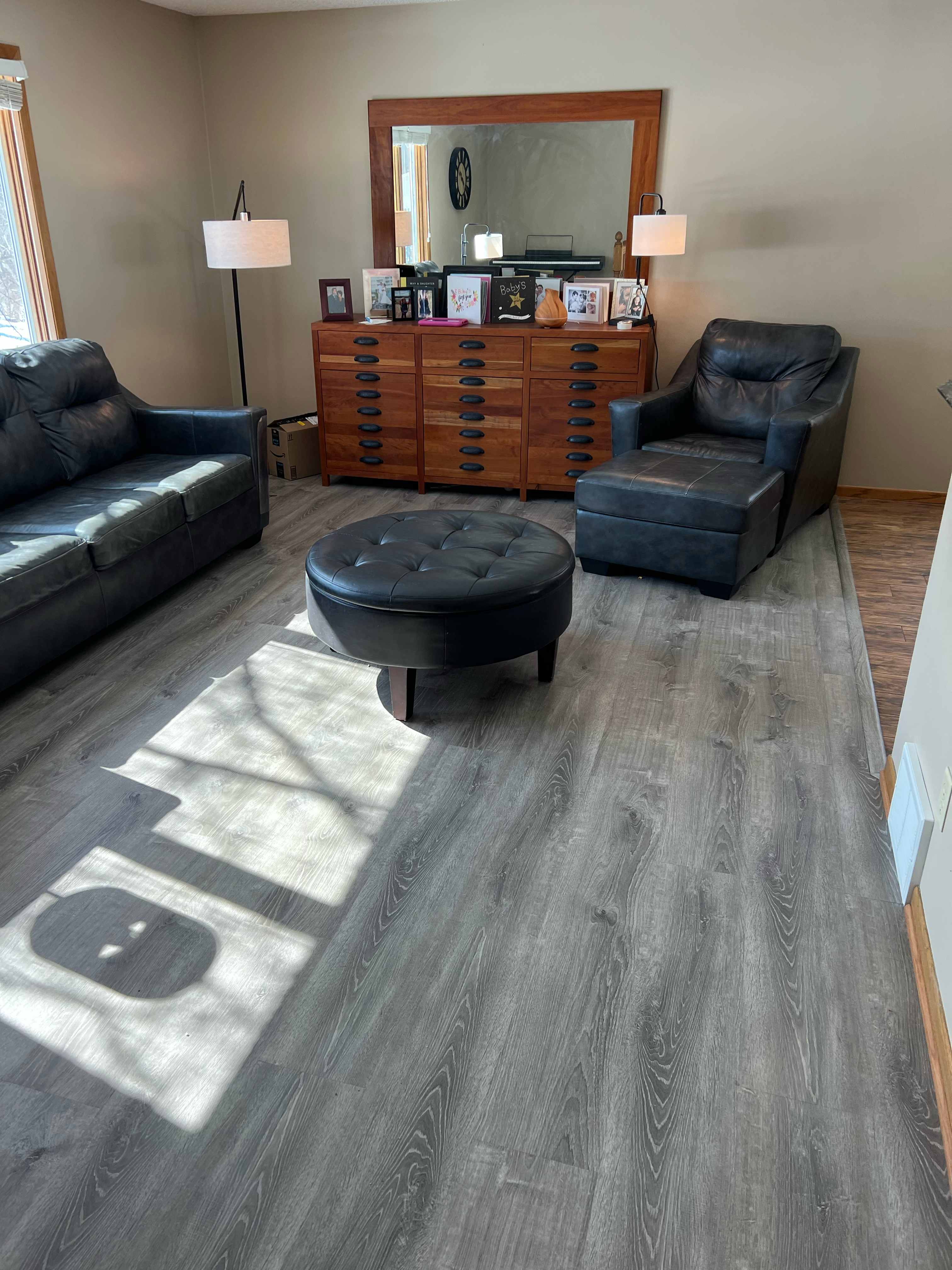 Modern living room with gray luxury vinyl plank flooring and contemporary furniture