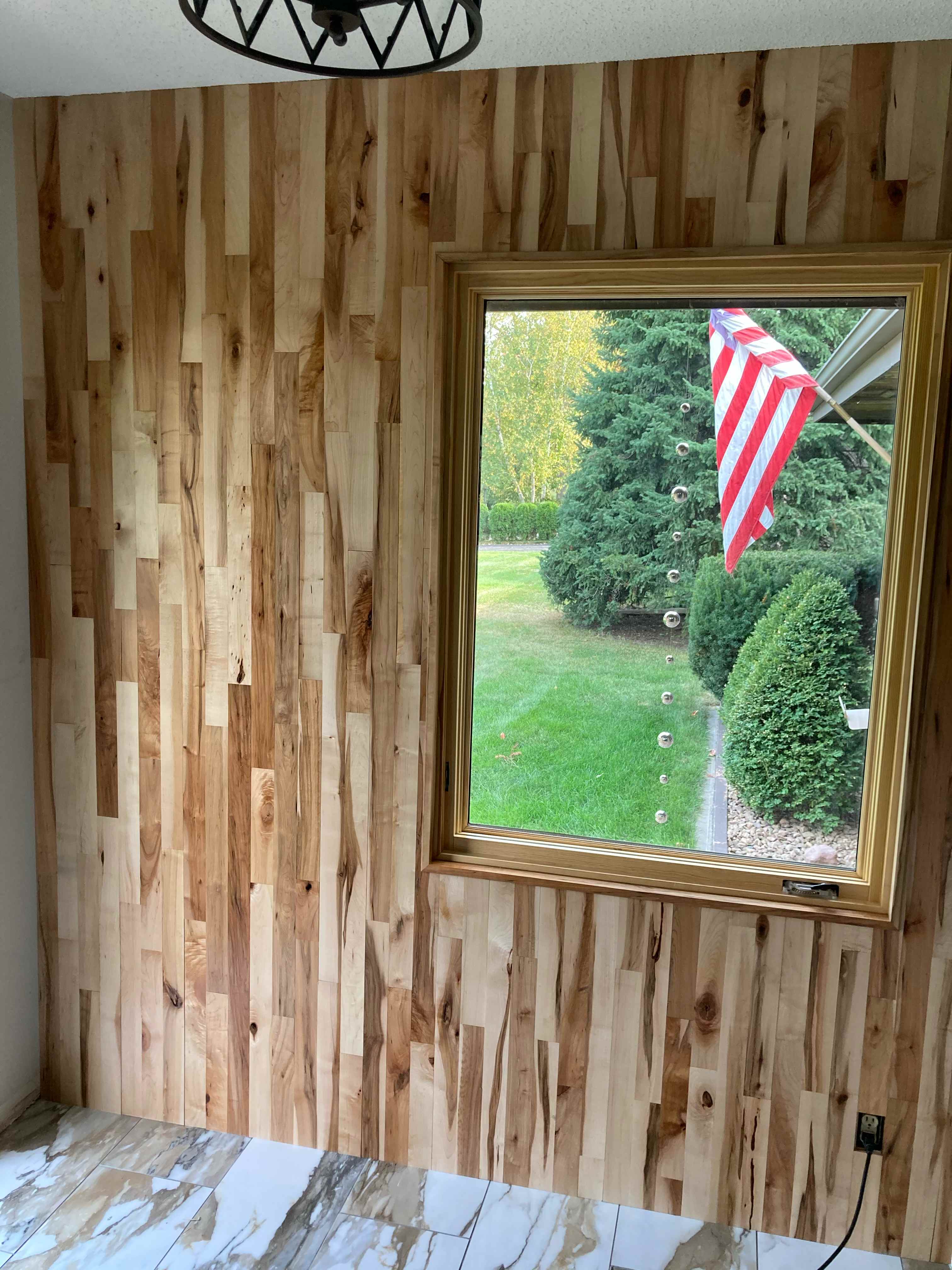 Custom wooden accent wall with varied wood tones and textures creating a focal point